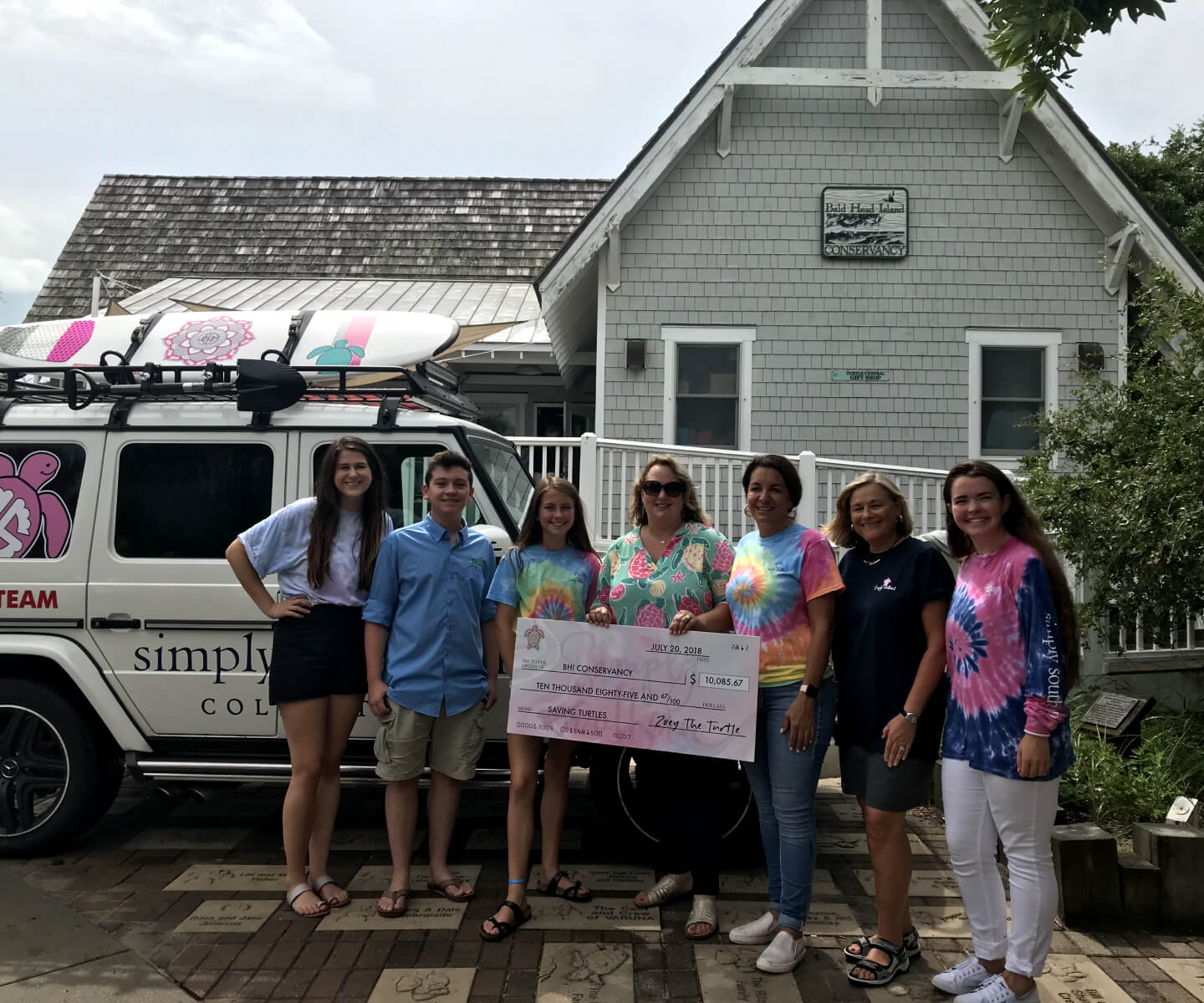 Simply Southern team presenting a donation check